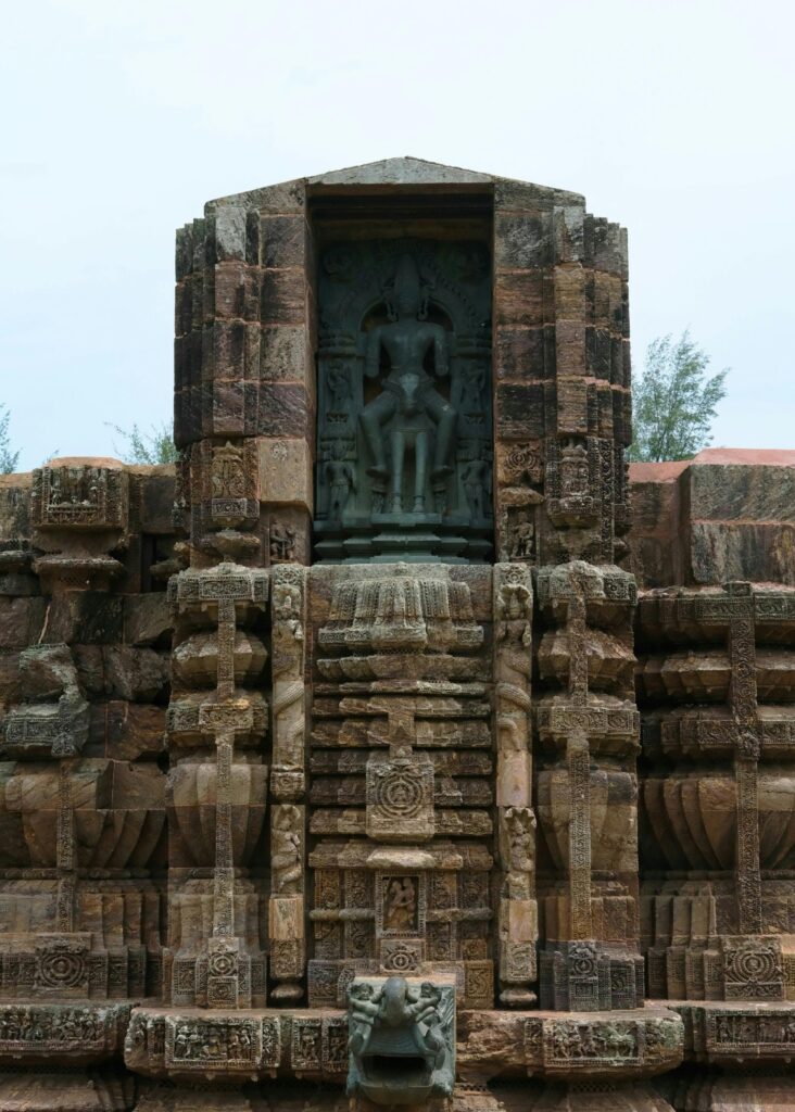 Detailed view of the historic Konark Sun Temple facade in India, showcasing exquisite carvings.